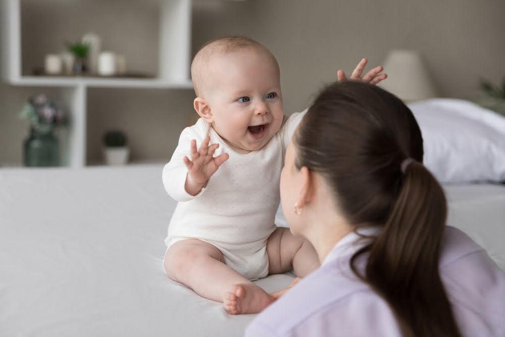 Happy excited baby laughing at mom face - Pediatric Vaccine in Ottumwa, IA